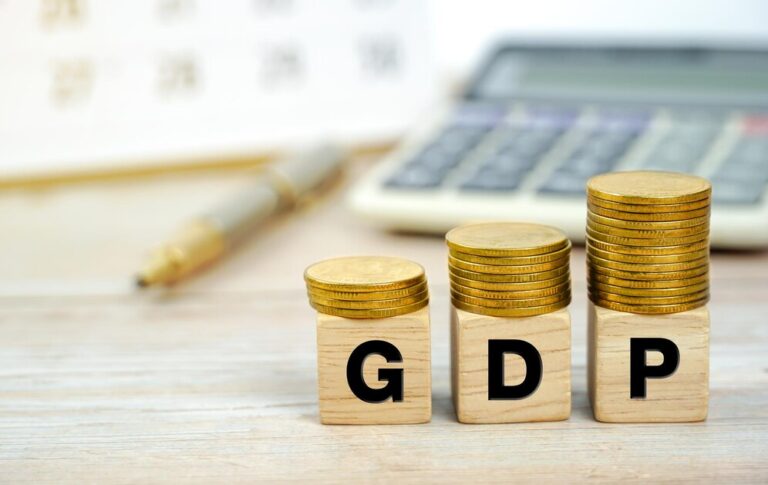 gdp-gross-domestic-product-wooden-block-letters-coins-desk-background-with-calculator_483511-4453