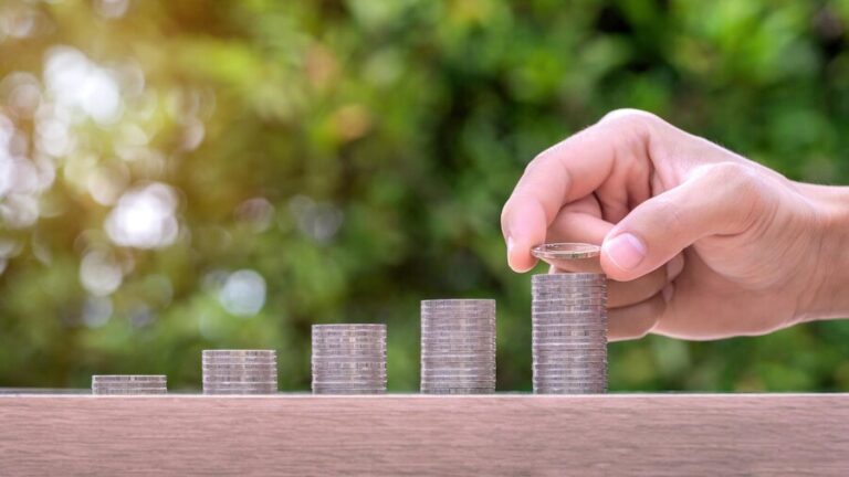 hand-holding-coin-stack-money-wood-table-pension-fund-concept_335224-1410