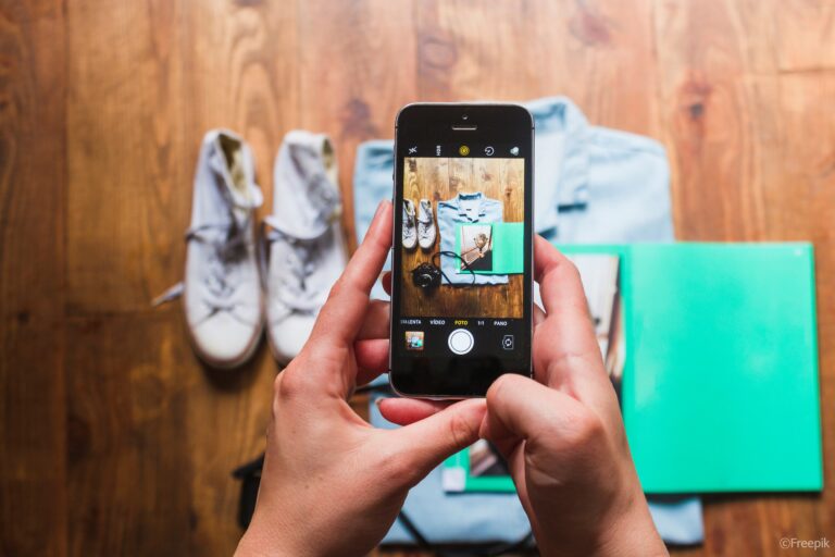 human-hand-taking-photo-personal-accessories-table