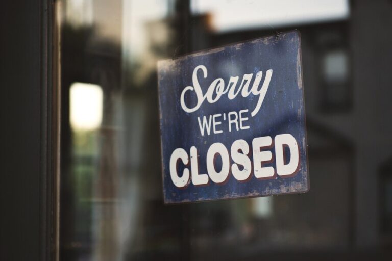 closeup-shot-sign-that-says-sorry-we-re-closed-hanging-glass-door_181624-21069