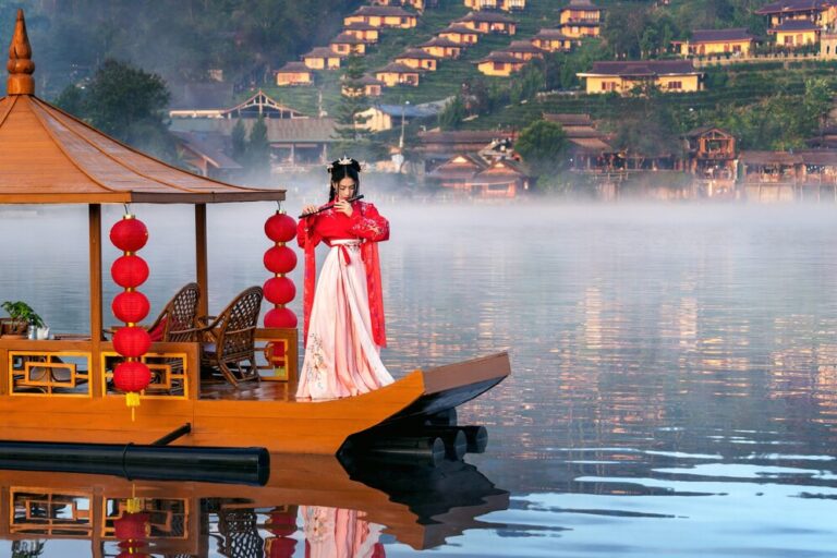 asian-woman-wearing-chinese-traditional-dress-yunan-boat-ban-rak-thai-village-mae-hong-son-province-thailand_335224-1171