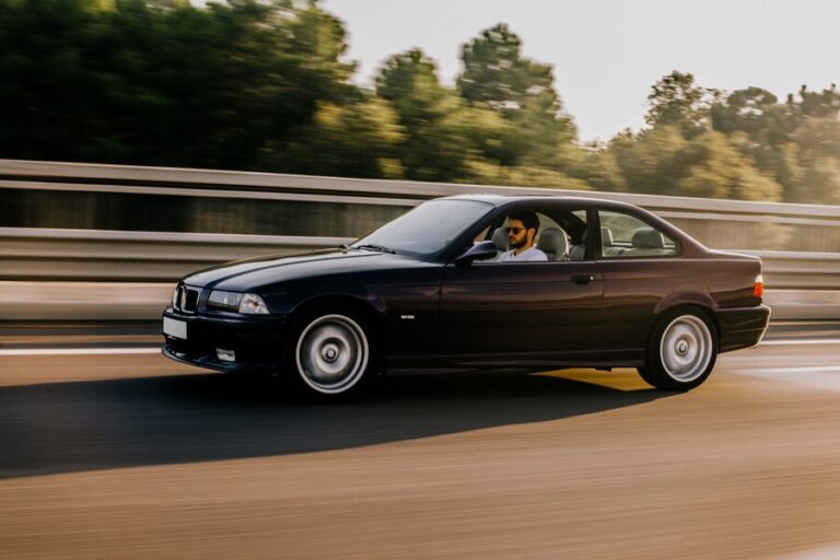 vintage-sedan-car-driving-highway-side-view_114579-5067